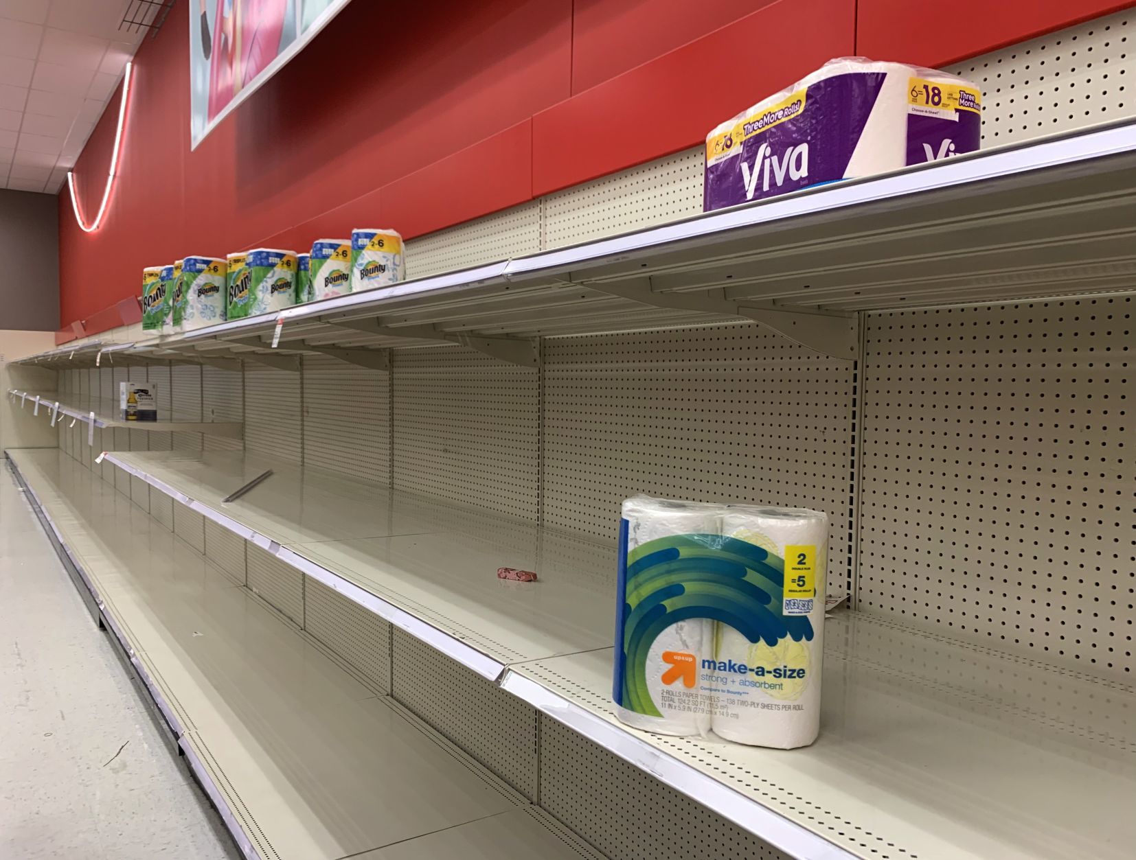 Empty shelves of disinfectatnt wipes, hand sanitizer and toilet paper